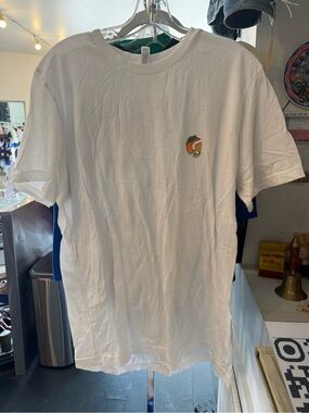 Glossier Mango Whie Tee with Small Colorful Fruit Logo